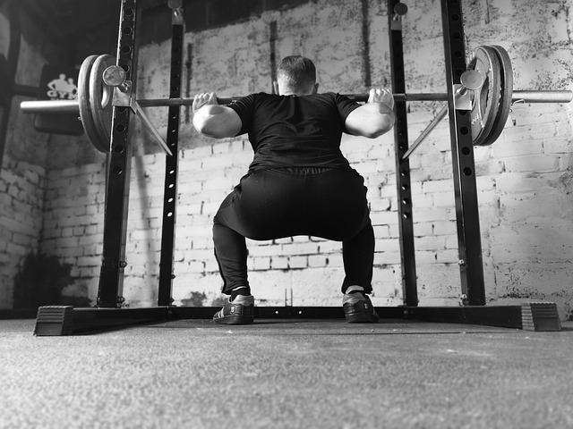 person weightlifting with a squat hold